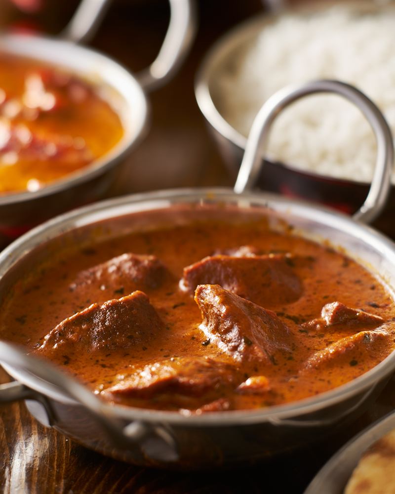 A slow-cooked curry in a copper kadai